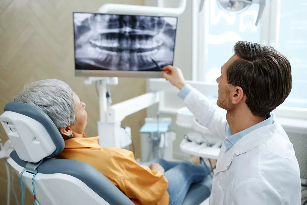 doctor explains dental implants in raleigh nc to a patient