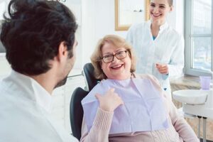 woman smiles as her dentist explains what a cone beam 3d cbct scan is
