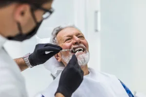 dentist helping patient with dental implant restoration in Raleigh