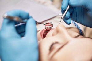 patient undergoing tooth extractions in dental office