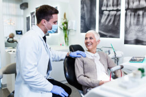 person in consultation about how to make your dentures fit better